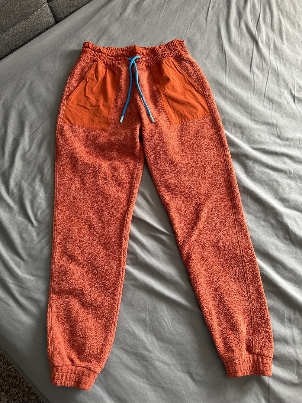 cotopaxi Orange Kids Fleece Joggers with Blue Drawstring